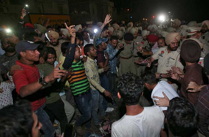 People gather near the site of a train accident at Joda Phatak in Amritsar, Friday, Oct 19, 2018. (Reuters Photo)