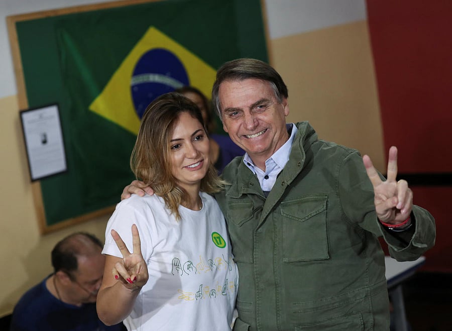 Jair Bolsonaro, far-right lawmaker and presidential candidate of the Social Liberal Party (PSL), poses with his wife Michelle as they arrive to cast their votes, at a polling centre in Rio de Janeiro, Brazil October 28, 2018. REUTERS
