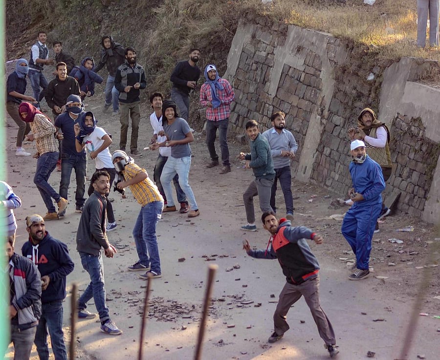 People take part in the traditional 'Pathar Mela', celebrated on the next day of Diwali, at Dhami near Shimla, on Thursday. PTI