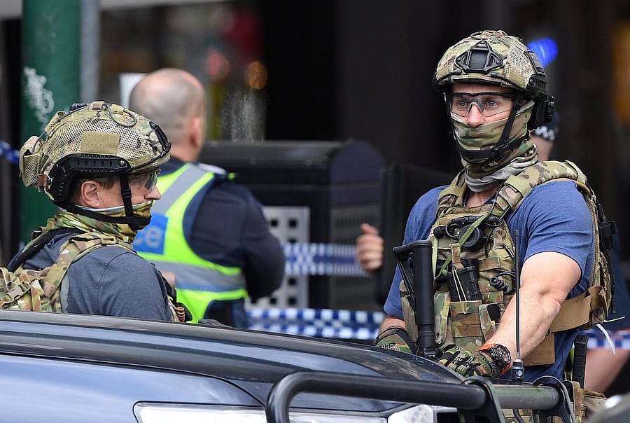 Armed security personnel stand near the Bourke Street mall in central Melbourne. Reuters Photo
