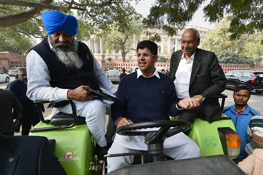 INLD MP Dushyant Chautala arrives by a tractor to attend the winter session of Parliament. PTI/FILE