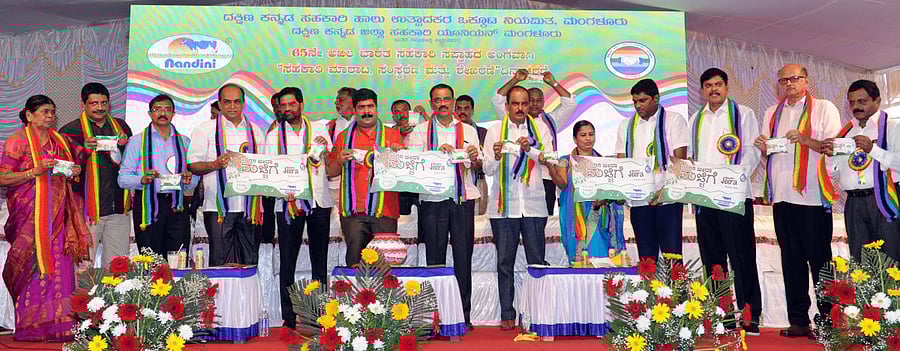 SCDCC Bank Chairman M N Rajendra Kumar and other dignitaries release 'Jeera Buttermilk,' during 65th All India Cooperative Week, at DKMUL dairy premises in Kulshekar on Wednesday.