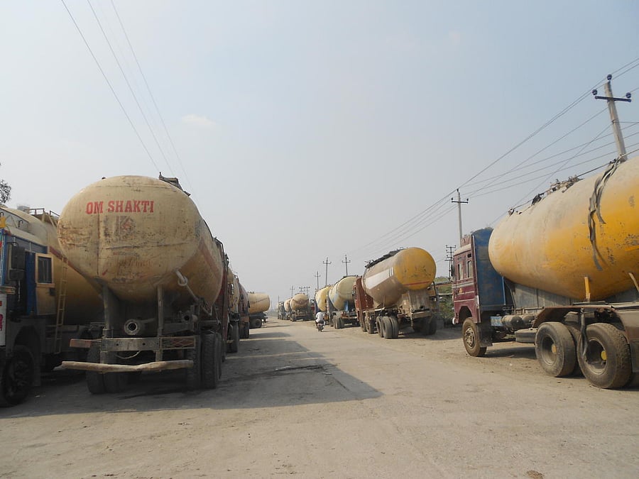 Lorries belonging to factories making cement, bricks, tiles and stone slabs for the pavements line up to lift fly ash from the Raichur Thermal Power Station. dh photo