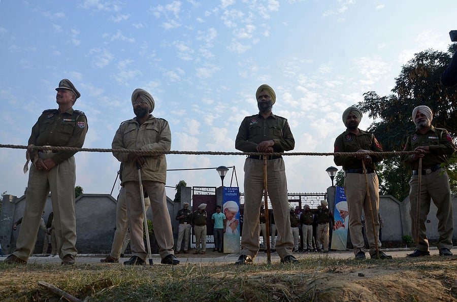 Police stand guard after a grenade blast outside a Sikh religious gathering site on the outskirts of Amritsar. Reuters photo