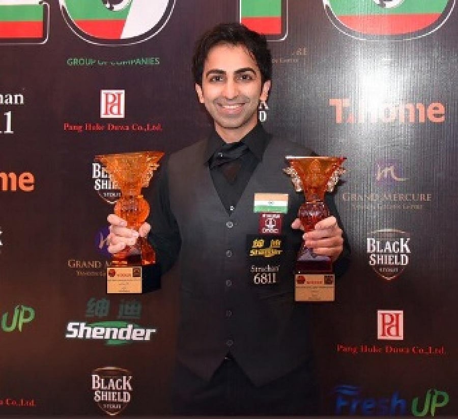 Pankaj Advani poses with the long and points format titles which he won in the ongoing IBSF World Billiards Championship. TWITTER