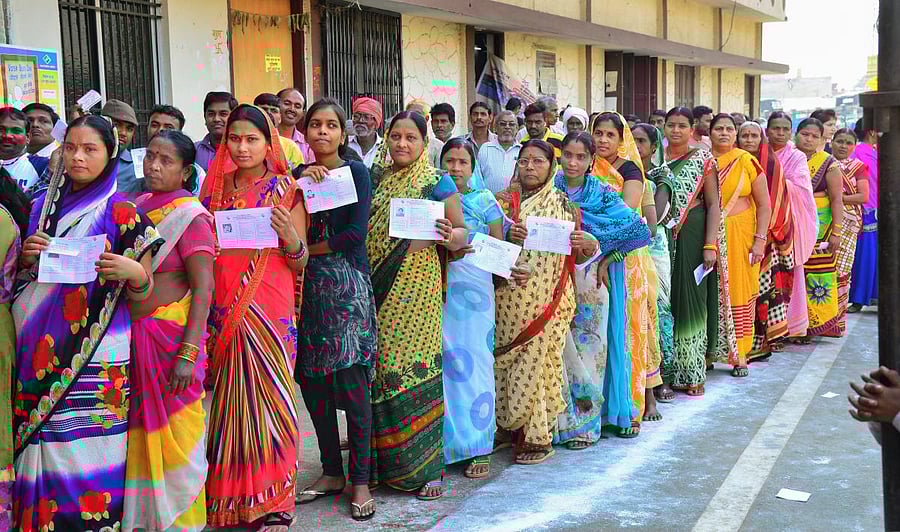 Raipur: Voters stand in a queue at a polling station to cast their votes for the 2nd phase of Assembly elections, in Raipur, Tuesday, Nov.20, 2018. (PTI Photo)(PTI11_20_2018_000037B)