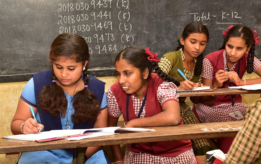 Visually impaired students attending the examination with the help of the scribes. DH Photo