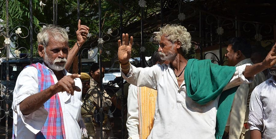Liquor lovers dance during a protest staged by them in front of the deputy commissioner's office in Dharwad on Thursday, demanding to open a liquor outlet in Hebballi. DH Photo