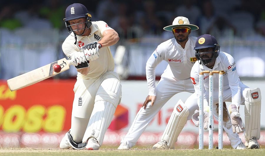 England's Jos Buttler sweeps one during his knock of 64 against Sri Lanka on Sunday. AFP