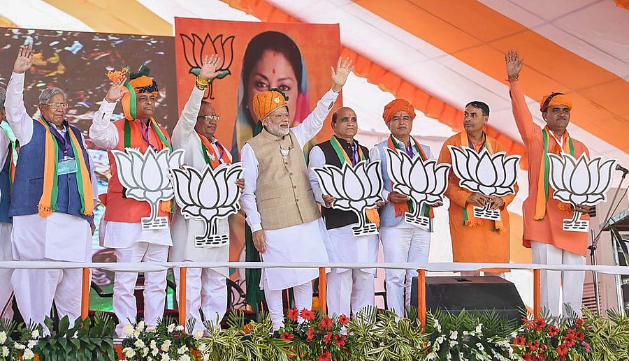 Prime Minister Narendra Modi waves at the crowd during an election rally