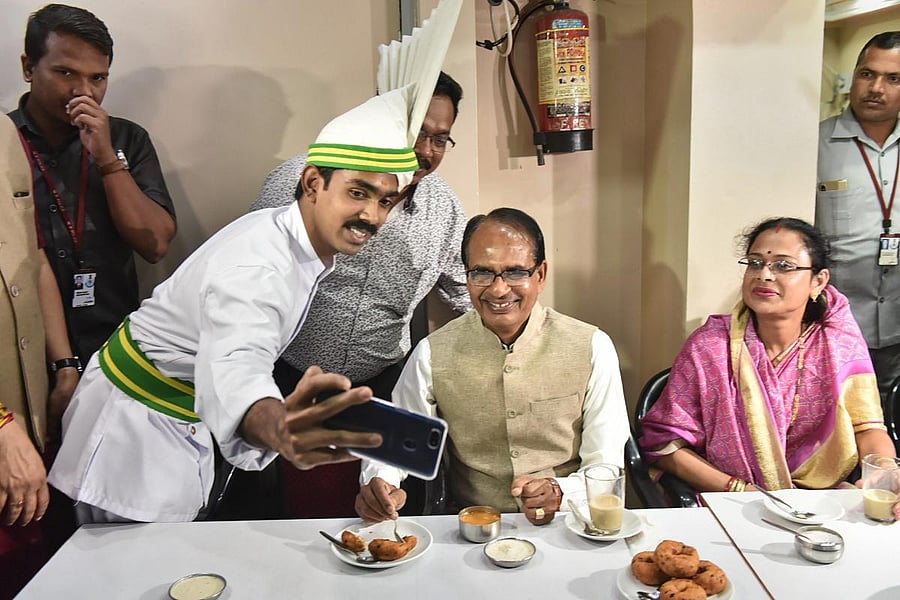 Madhya Pradesh Chief Minister Shivraj Singh Chouhan with his wife Sadhna Singh pose for a selfie at Indian Coffee House, in Bhopal. PTI Photo