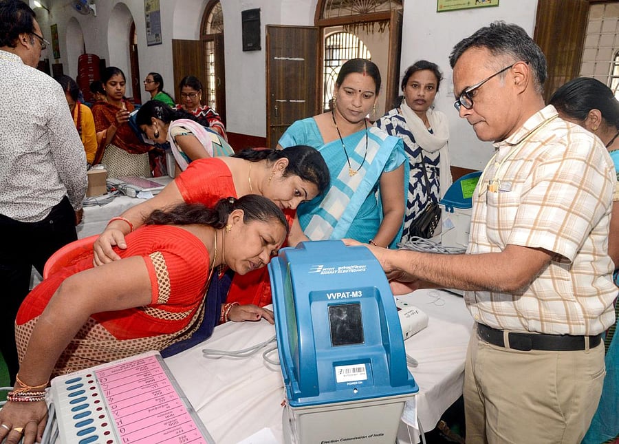 Electoral officials demonstrate the functioning of an Electronic Voting Machine and Voter-Verified Paper Audit Trail during a voter awareness program ahead of Madhya Pradesh State Assembly elections, in Jabalpur on Friday. PTI
