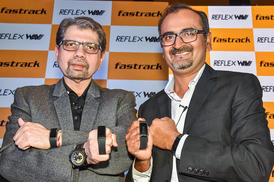 Titan CEO- Watches and Accessories S Ravi Kant (L) and Titan Business Head- Wearables Somprabh Kumar Singh pose with the Reflex WAV watch in Bengaluru on Thursday. DH Photo