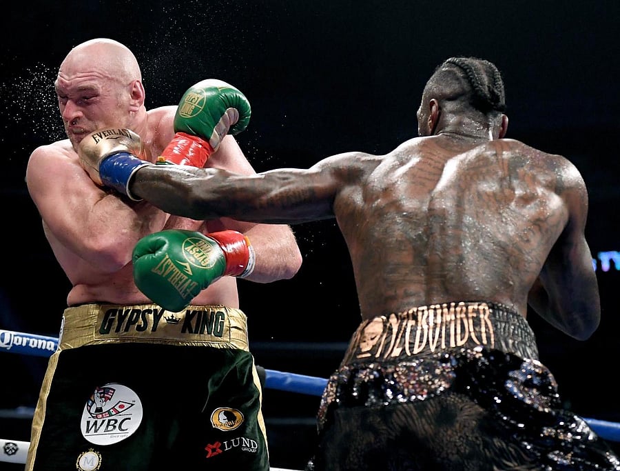 Deontay Wilder lands a punch on Tyson Fury during their WBC Heavyweight title bout in Los Angeles on Saturday. AFP