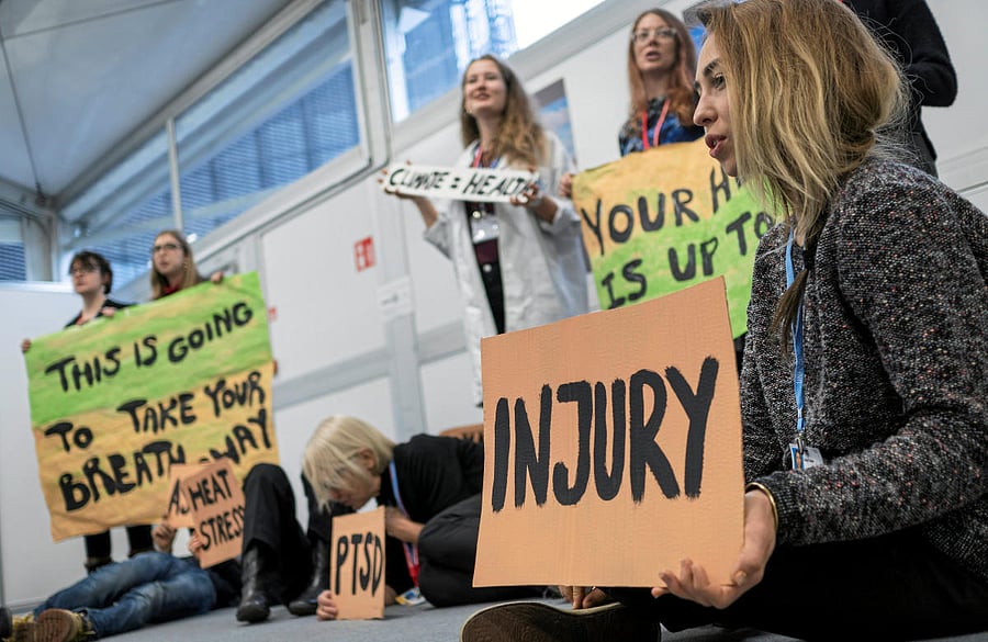 Environmental activists hold placards during a "Climate Is Health" protest during the COP24 U.N. Climate Change Conference 2018 in Katowice, Poland. Reuters