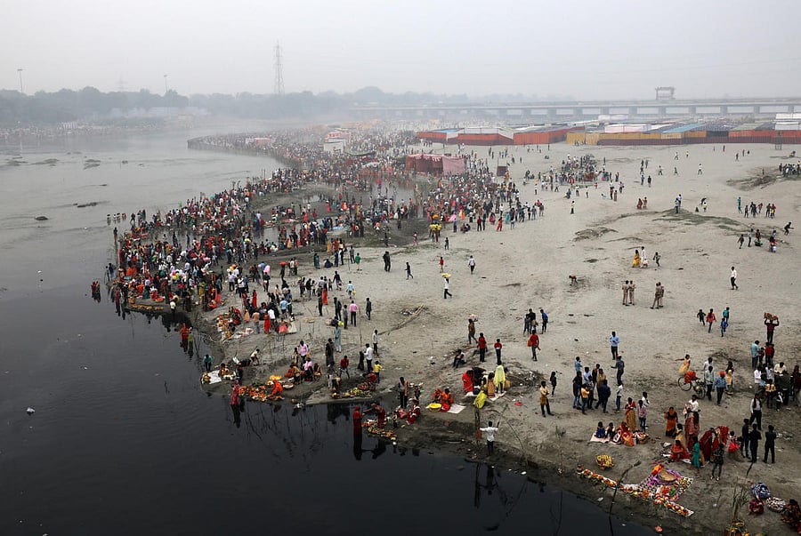 Hindu devotees gather on the banks of the Yamuna river to worship the Sun god during the Hindu religious festival of Chhath Puja in New Delhi, India, November 13, 2018. REUTERS/Anushree Fadnavis