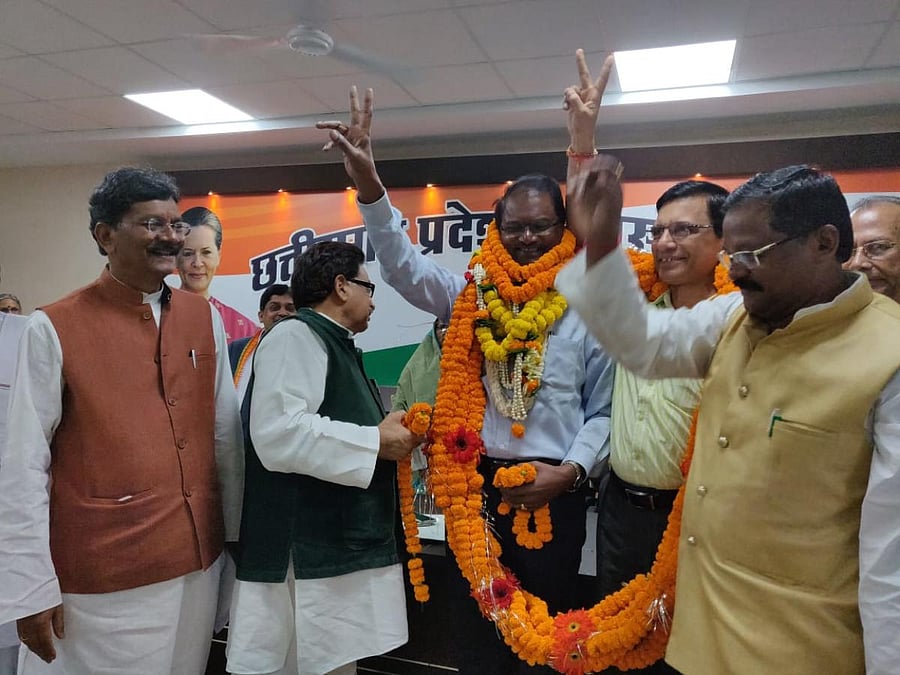 Serjius Minj, along with R P S Tyagi, being garlanded in presence of Congress leaders after he took the primary membership of the party on Sunday in Raipur.