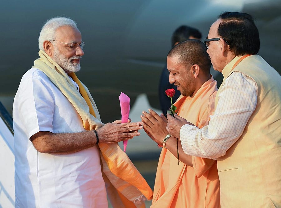Prime Minister Narendra Modi being welcomed by the Chief Minister of Uttar Pradesh Yogi Adityanath, on his arrival in Varanasi, Uttar Pradesh, September 17, 2018. (PIB Photo via PTI)