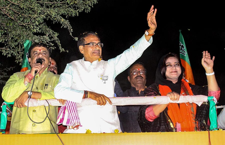 Madhya Pradesh Chief Minister Shivraj Singh Chouhan at a roadshow in support of BJP candidate from Bhopal North assembly constitutency Fatima Rasool Siddiqui (R) for State Assembly election, in Bhopal. PTI Photo