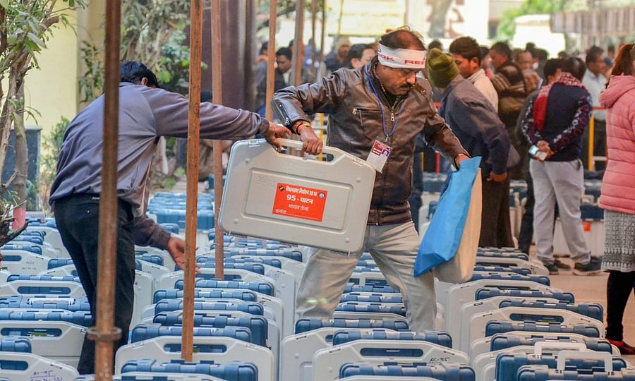 Election officials collect their Electronic Voting Machine (EVM) from an EVM distribution centre in Jabalpur. Congress has charged that BJP was manipulating the EVMs with bluetooths. PTI