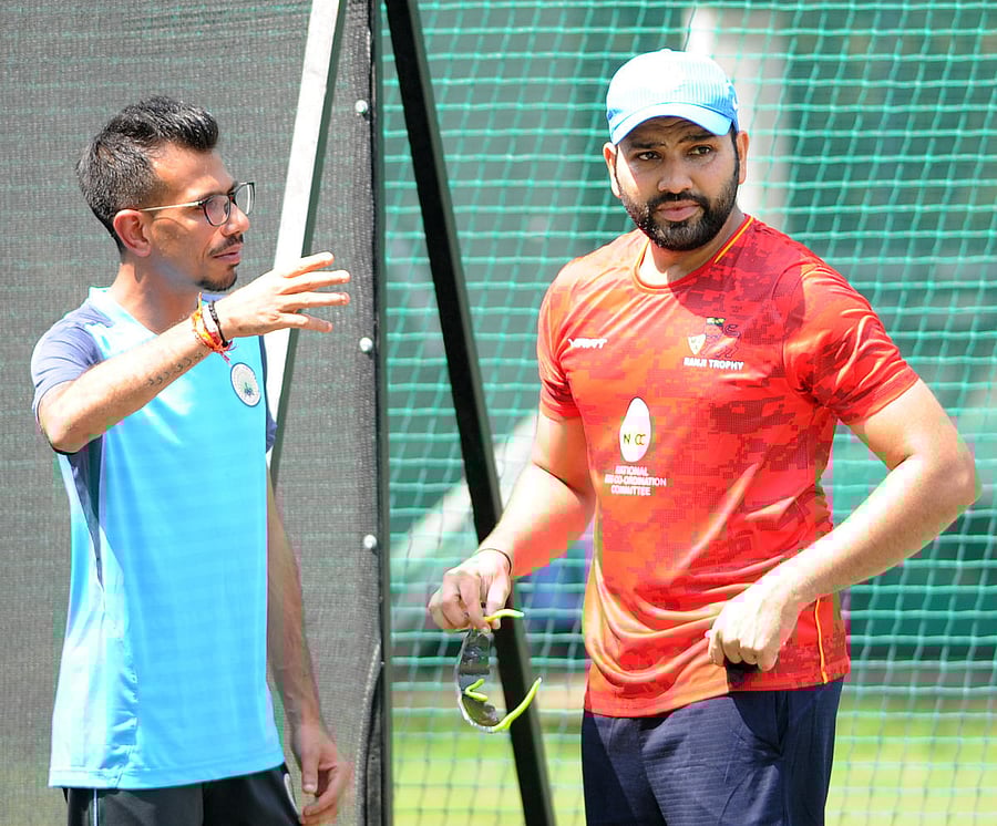 Mumbai's Rohit Sharma (right) and Haryana's Yuzvendra Chahal discuss a point during a practice session at the Chinnaswamy Stadium on Saturday. DH PHOTO/ SRIKANTA SHARMA R