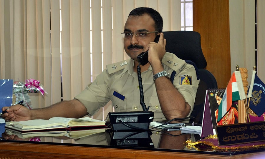Superintendent of Police Lakshman Nimbargi receives a call during the weekly phone in programme in Udupi on Friday.