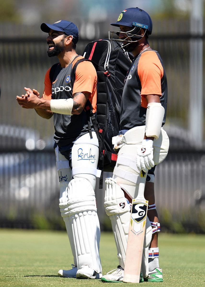  India skipper Virat Kohli (left) and Cheteshwar Pujara in a jovial mood during Thursday's practice session at Optus Stadium. AFP