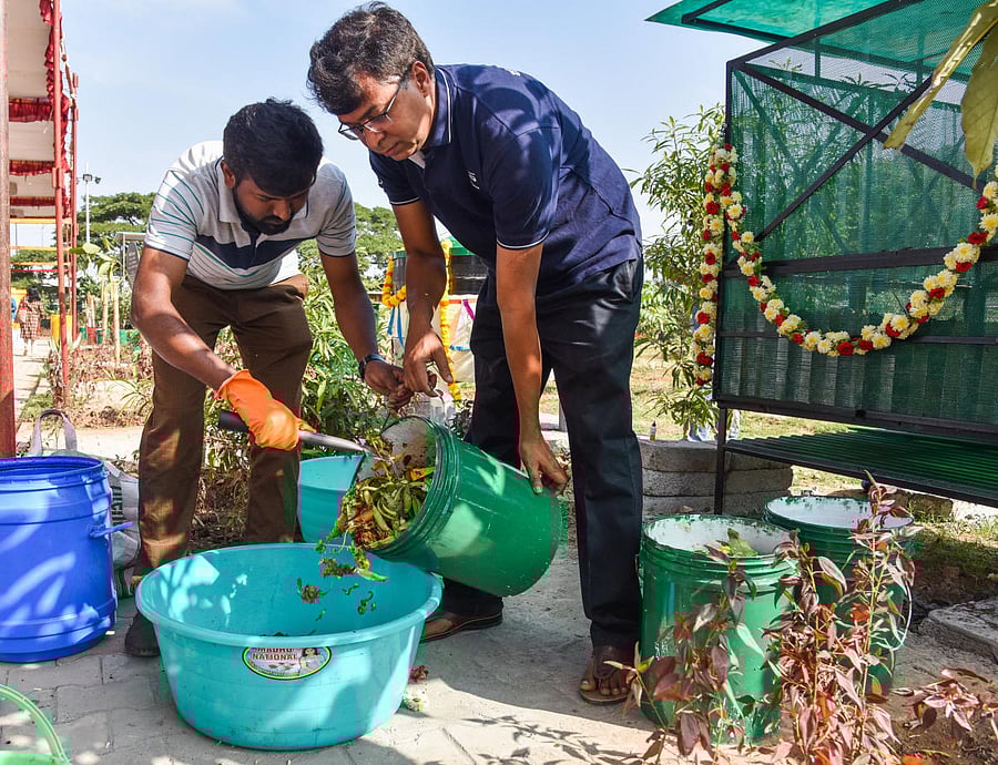 Residents demonstrate how house waste can be converted to compost at the SwachaGraha Kalika Kendra. DH PHOTO/S K Dinesh