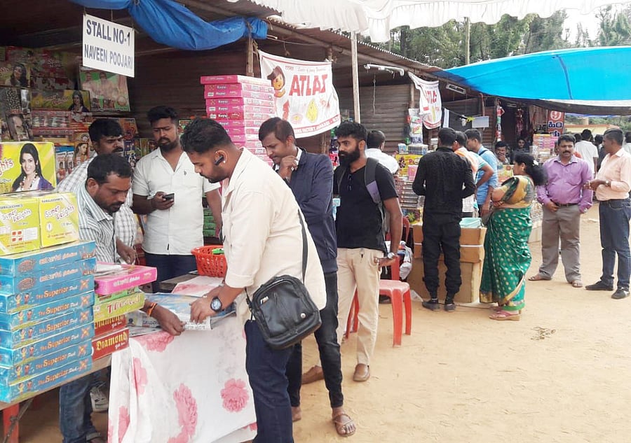 People purchase firecrackers for Huttari festival.