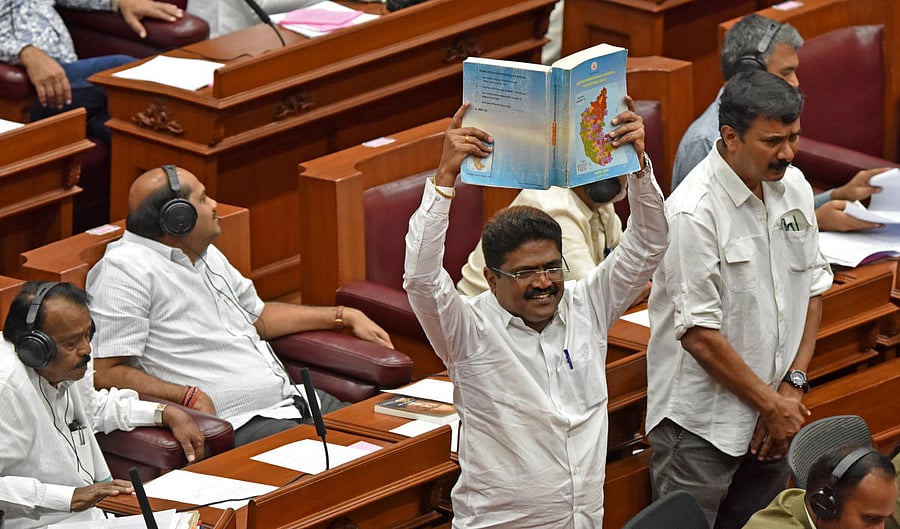 RAISING VOICE: BJP members stage a protest in the Legislative Council demanding a discussion on the problems faced by North Karnataka, during the legislature session in Belagavi on Friday. dh photo