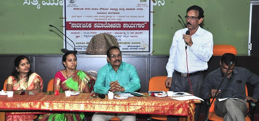 KUIDFC Assistant Executive Engineer Ramakrishnaiah speaks at a consultative meeting in Udupi.