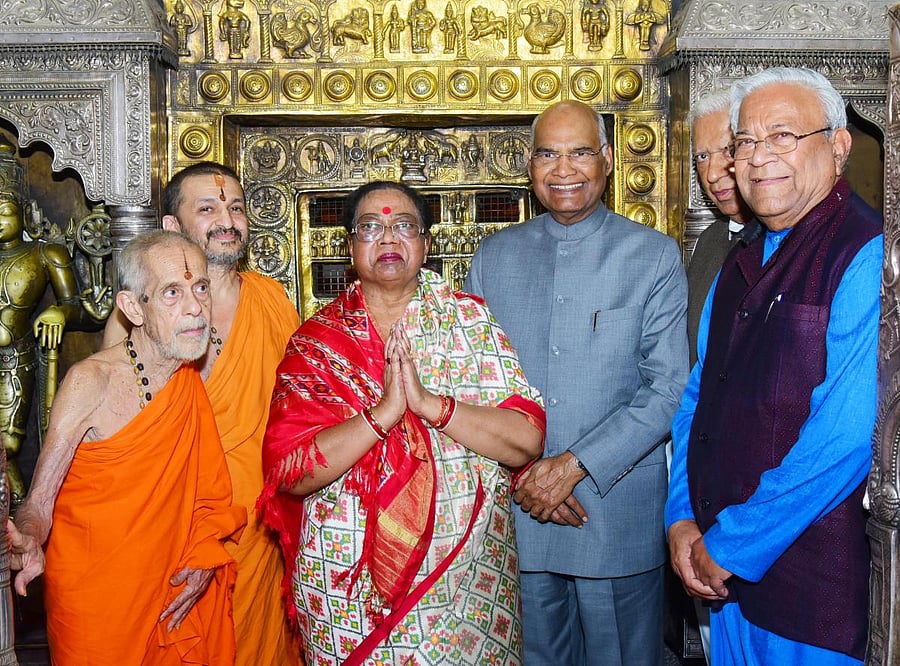President Ram Nath Kovind, along with his wife Savita Kovind, poses after having the darshan of Lord Krishna at Sri Krishna Temple in Udupi on Thursday. Pejawar Mutt Pontiff Vishwesha Teertha Swami, Paryaya Palimar Pontiff Vidyadeesha Swami and others loo