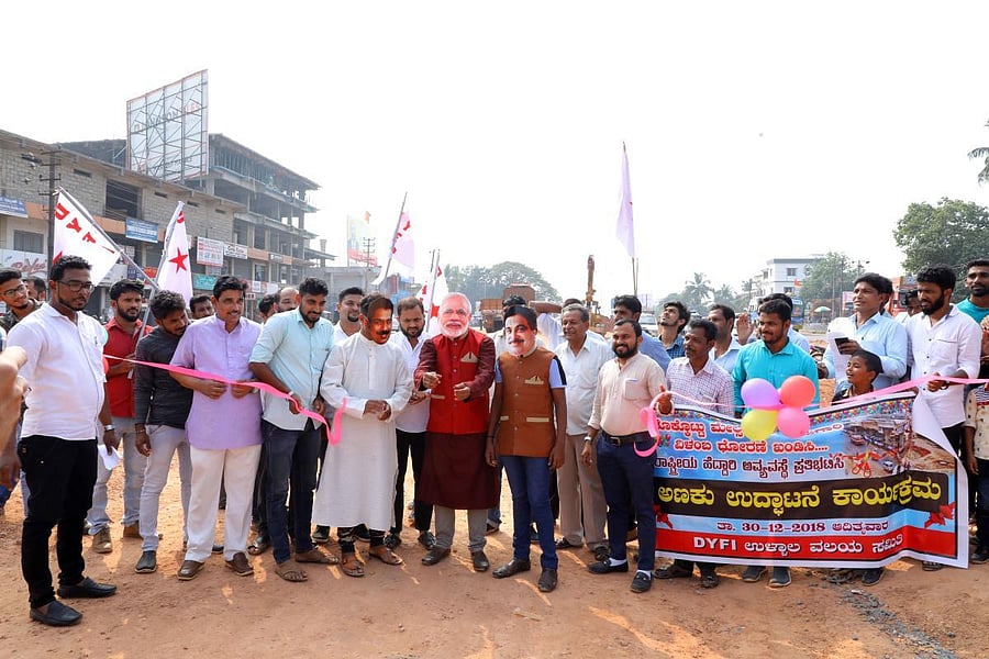 DYFI Ullal unit members stage a mock inauguration of Thokkottu flyover at Thokkottu. 