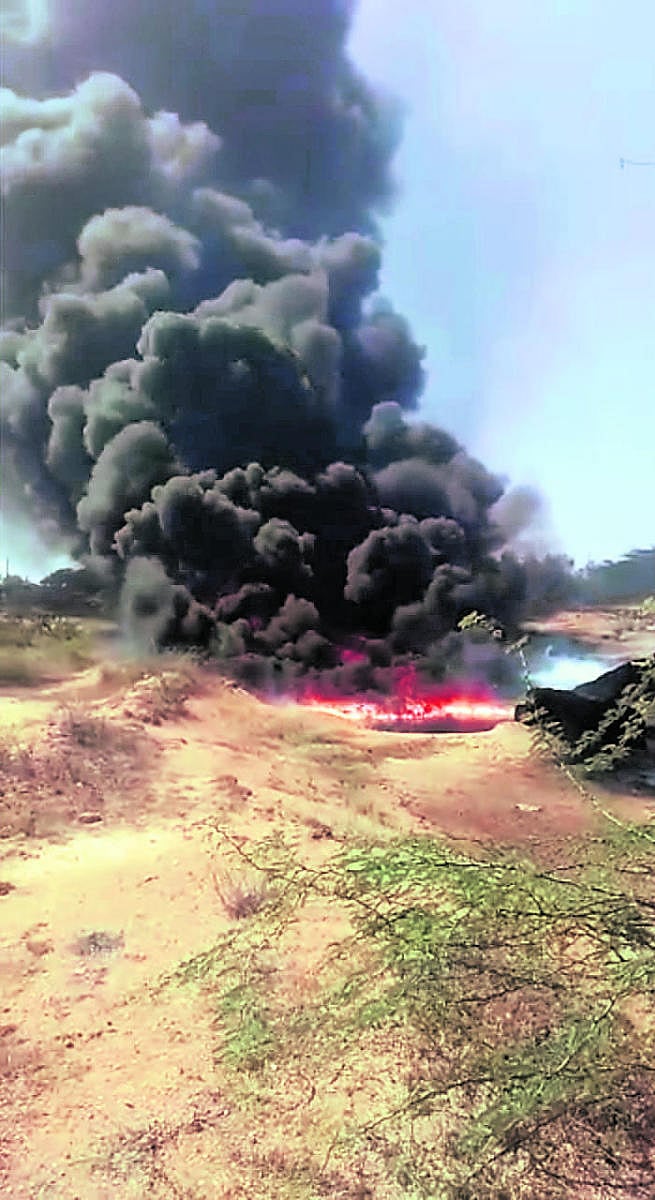 Dense smoke billows from a water body located near Barjaanukunte village in Gauribidanur taluk on Wednesday morning.