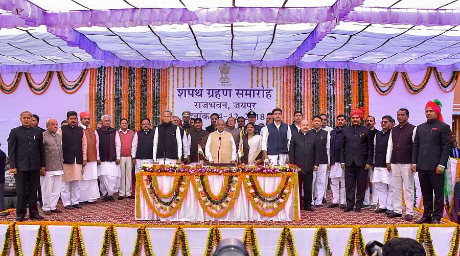 Rajasthan Governor Kalyan Singh, Chief Minister Ashok Gehlot, Deputy Chief Minister Sachin Pilot pose for a photograh with the newly sworn-in cabinet ministers during a ceremony at Raj Bhawan, in Jaipur. PTI photo