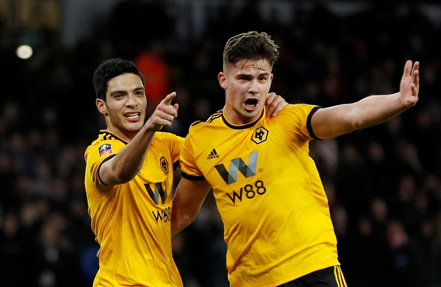 Wolverhampton Wanderers' Raul Jimenez (left) celebrates with team-mate Leander Dendoncker after scoring against Liverpool on Monday. REUTERS
