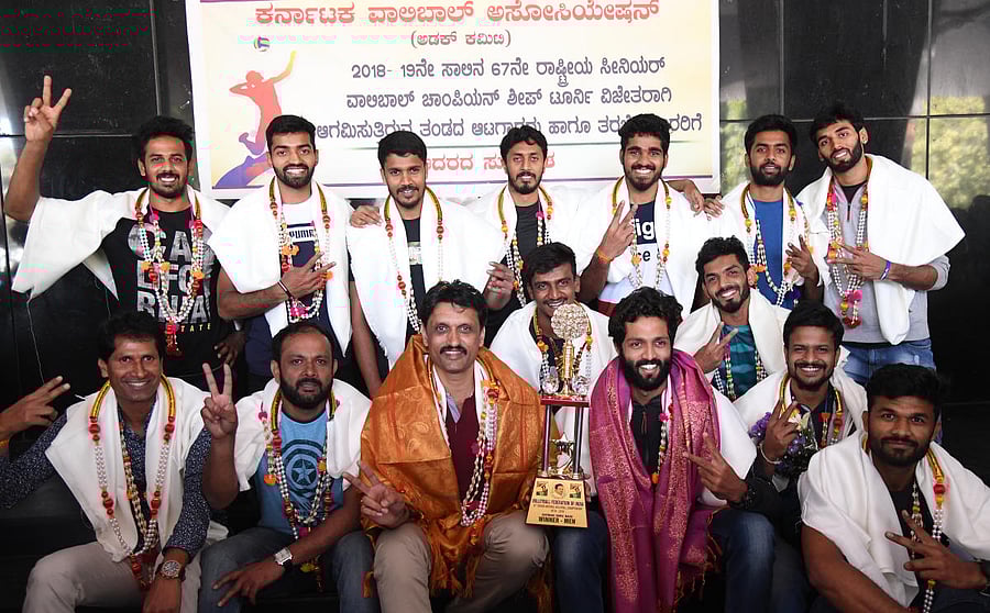 Karnataka men’s team, winners of the 67th Senior National Volleyball championship in Bengaluru on Friday. STANDING (From left) Nakul Dev, Ganesh, Ravikumar, Karthik S A, Raison, Pratheek Shetty, Ashwal Rai. SITTING: P C Satish (Manager), Vishu Kumar (Asst coach), K R Lakshninarayana (coach), Darshan Gowda, Bharath, Karthik A, Vinayak, Sujith Acharya. DH Photo