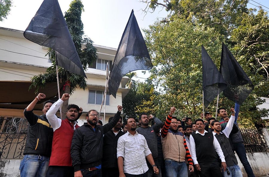 Members of All Assam Students' Union with black flags in Guwahati on Saturday. (Photo by Manash Das)
