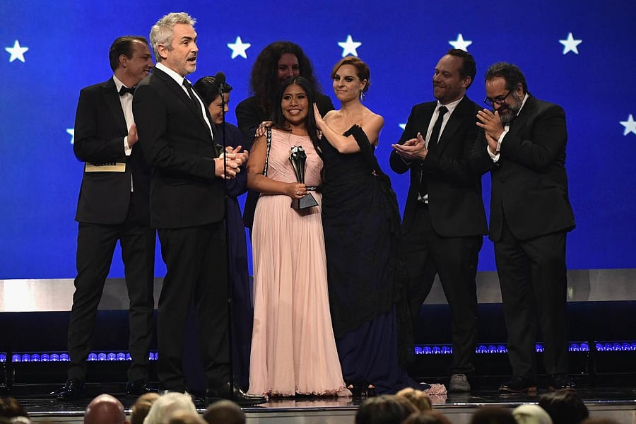SANTA MONICA, CA: (L-R) Nicolas Celis, Alfonso Cuaron, Yalitza Aparicio, Adam Gough, Marina De Tavira, Jeff Skoll, and Eugenio Caballero accept the Best Picture award for 'Roma' onstage during the 24th annual Critics' Choice Awards at Barker