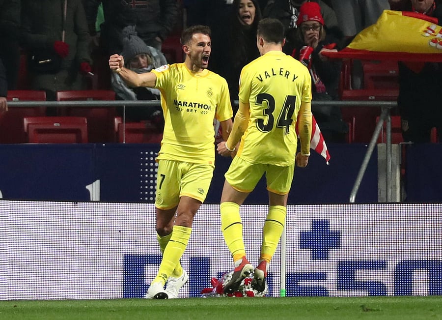 Girona's Cristhian Stuani celebrates with team-mate Valery Fernandez after scoring against Atletico Madrid on Wednesday. REUTERS