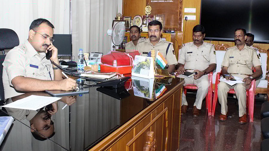 Udupi Superintendent of Police Laxman Nimbargi receives a call during the phone-in programme in Udupi.