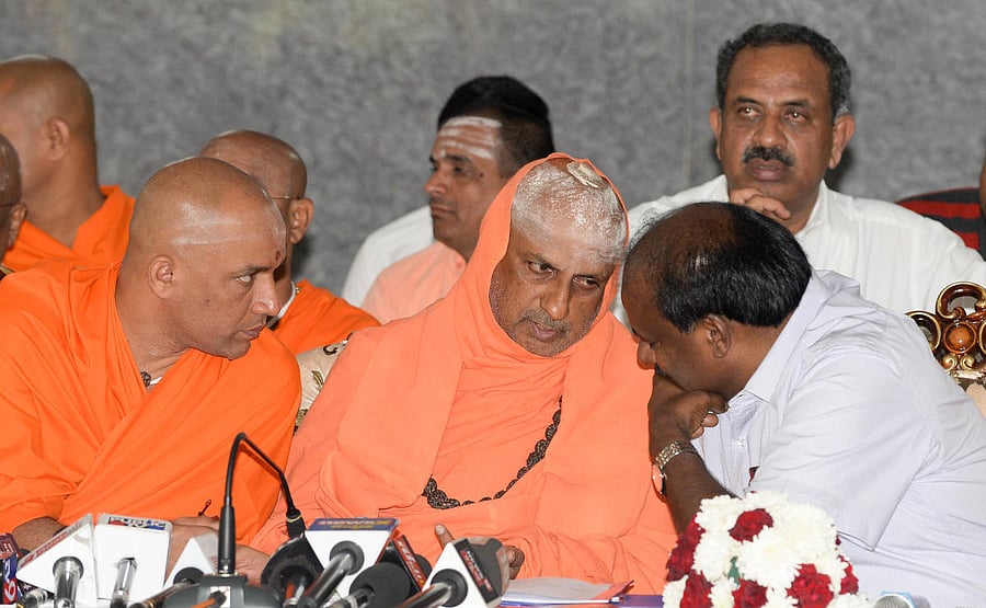 hief Minister H D Kumaraswamy speaks to Suttur Mutt seer Shivaratri Deshikendra Swami and Adichunchanagiri Mutt seer Nirmalanandanatha Swami during a meeting convened to dicuss preparations to be made for the Kumbh Mela to be held in T Narasipura, in Beng