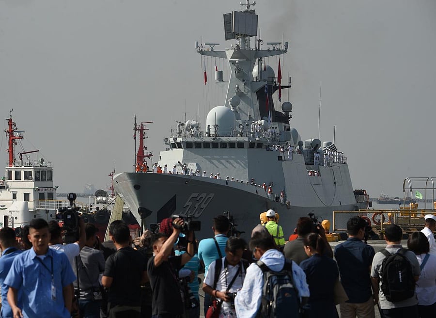 Journalists wait for the arrival of Chinese guided-missile frigate Wuhu at the international port in Manila on January 17, 2019. AFP