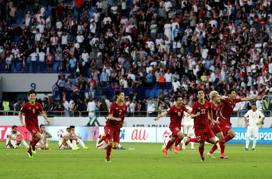 Vietnam players celebrate their round-of-16 win over Jordan on Sunday. AFP