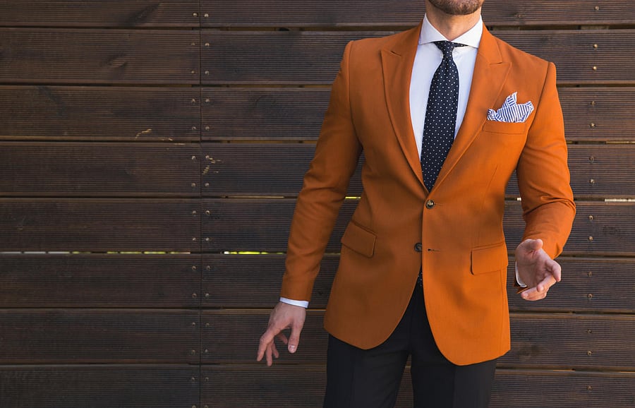 A grey shirt teamed up with pleated coral trousers and with black loafers or moccasins will lend an enriching look.