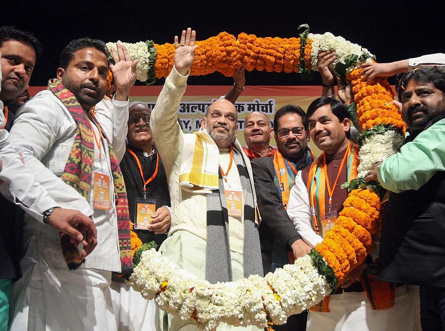 BJP president Amit Shah being garlanded during Muslim Minority Sammelan, in New Delhi, Thursday. PTI