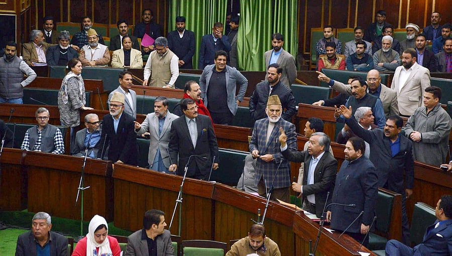 National Conference and Congress MLA's protest inside the J&K Legislative assembly during the budget session in Jammu on Wednesday. PTI