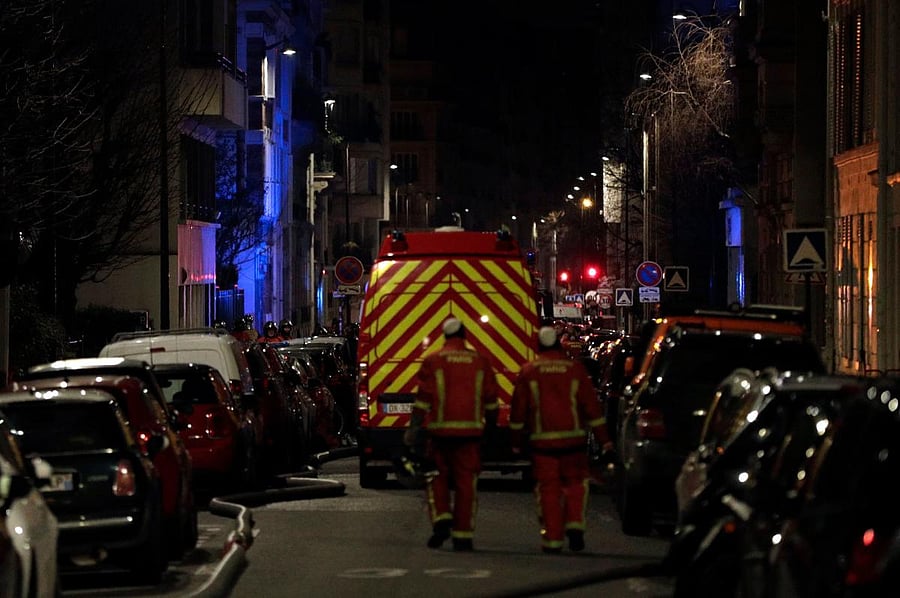 Firefighters are seen near a building that caught fire in the 16th arrondissement in Paris. AFP.