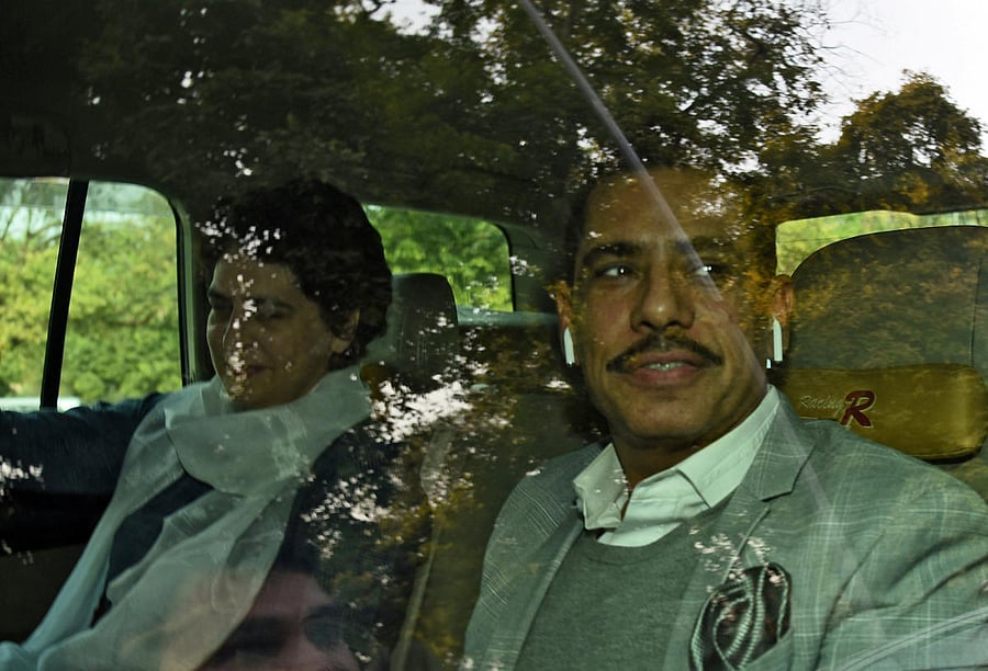 Priyanka Gandhi Vadra and her husband Robert Vadra are pictured outside the Enforcement Directorate, in New Delhi on Wednesday. REUTERS