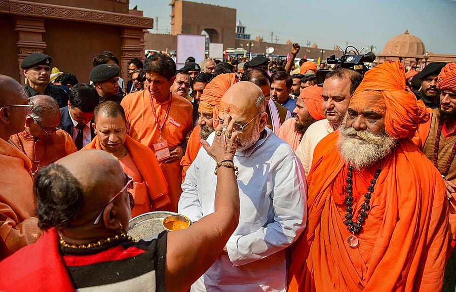 BJP president Amit Shah, accompanied by Uttar Pradesh Chief Minister Yogi Adityanath, meets the sadhus at Juna Akhara ashram during his visit to Kumbh Mela 2019 in Prayagraj (Allahabad), on Wednesday. PTI